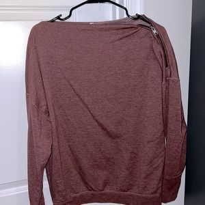 zipper detailing on one shoulder. Sweatshirt like material, on the thinner side